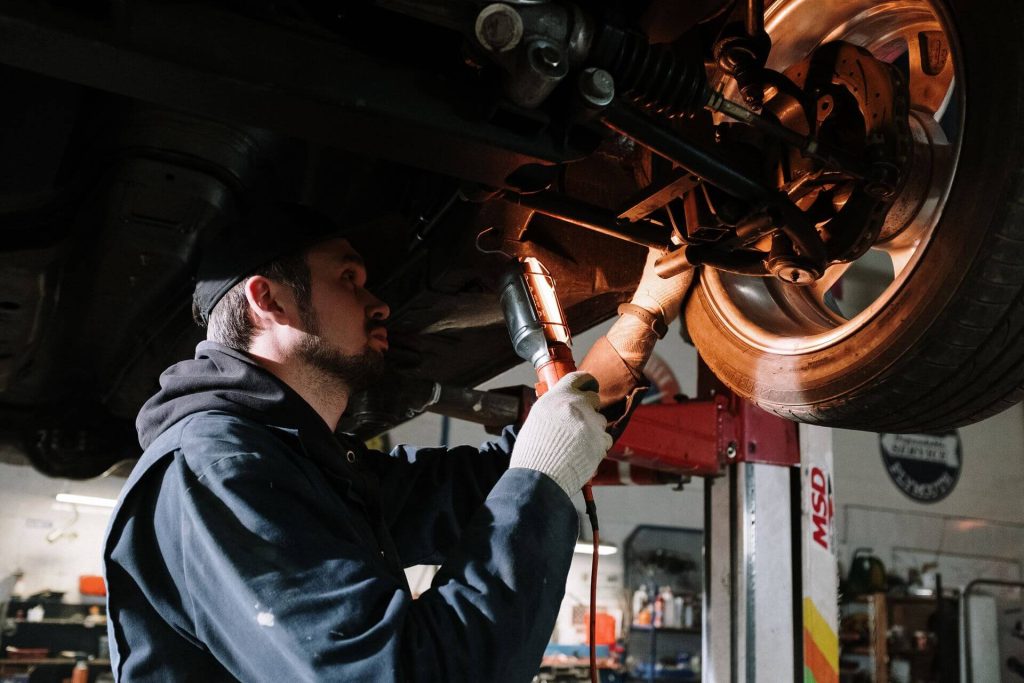 remap wigan 6 mechanic repairing car under lift